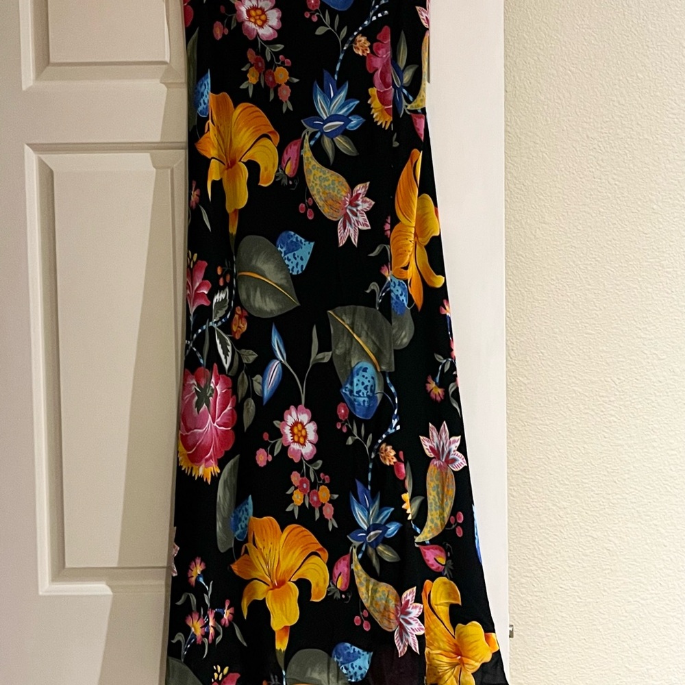 Long black skirt with tropical flowers and plants in bright brilliant colors.